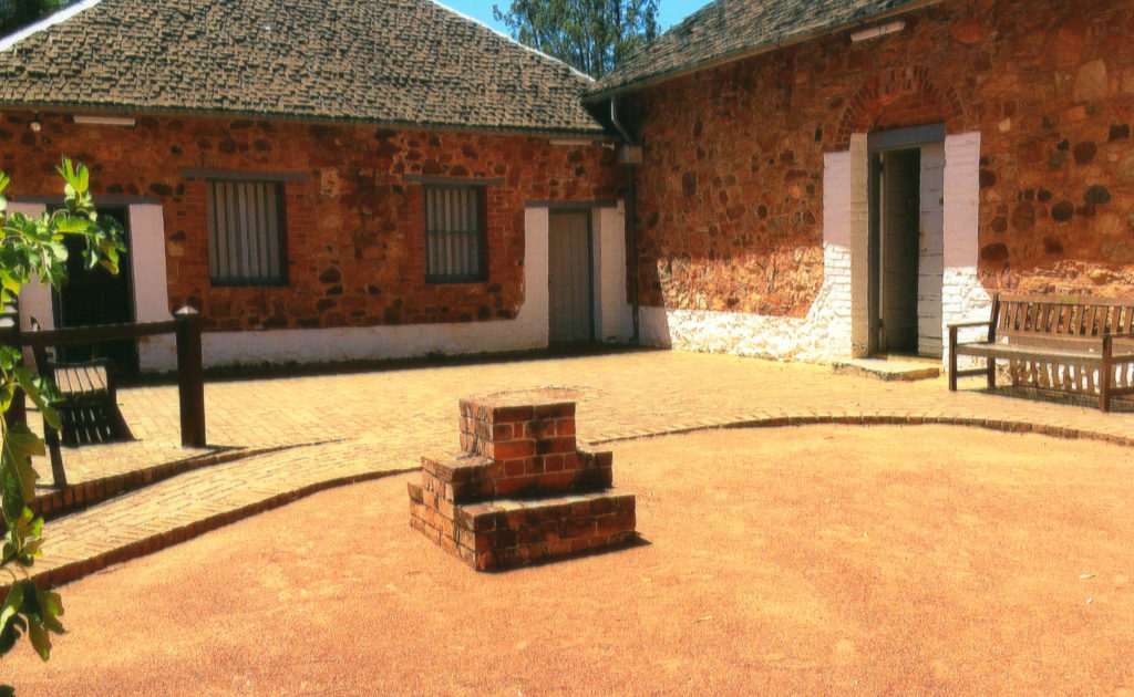 Museum entry (door on right) from main building into courtyard.