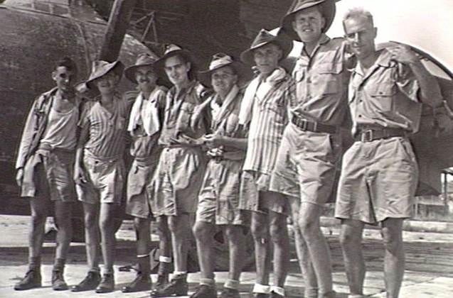 SINGAPORE. 1945-09-09. MEMBERS OF 8TH AUSTRALIAN DIVISION, EX-PRISONERS OF WAR OF THE JAPANESE, AT KALANG AERODROME WAITING TO GREET MEMBERS OF THE 1ST AUSTRALIAN PARATROOP BATTALION ON THEIR ARRIVAL FROM LABUAN. IDENTIFIED PERSONNEL ARE:- SAPPER (SPR) D. H. HERBERT, 2/6TH AUSTRALIAN FIELD PARK COMPANY (2); DRIVER R. J. LEES, 2/18TH AUSTRALIAN INFANTRY BATTALION (3); SPR J. HUNTEL, 2/10TH AUSTRALIAN FIELD COMPANY (4); PRIVATE (PTE) J. W. CLAY, 2/4TH AUSTRALIAN MACHINE GUN BATTALION (5); PTE G. J. WADE, 2/4TH AUSTRALIAN MACHINE GUN BATTALION (6); SIG C. BROOKES, 8TH AUSTRALIAN DIVISION SIGNALS (8).