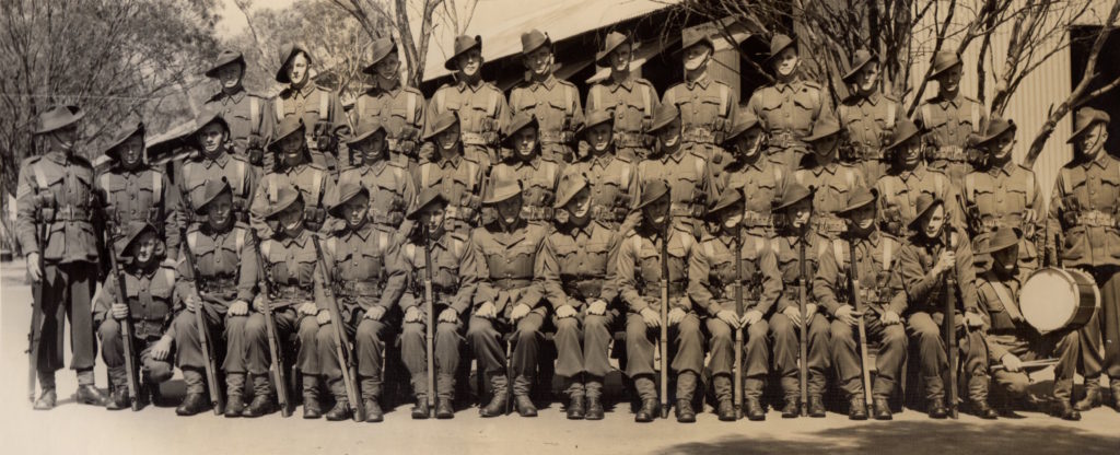 Military Drill Display Northam Show 24/09/1941 Reinforcements General not allocated at that stage. Back row L-R L/cpl McGhie, Pte Smith, Trigwell, Smith, Lewis, Godden, Cake, Lucas, Foster, L/cpl Hatch Centre Sgt Graham, Pte Salter, Atkinson, L/cpl Boyle, Pte Knight, Shepherd, Doherty, Sloan, Pierce, Dawson, Perkins, Anderson, Watts, Cpl Scott. Front Pte Brown, L/cpl Negri, Pte Pascall, Mc Glinn, Holt, Lieut Gibson, (A Coy Comm), Lieut Branson (Display Comm), Pte Hardey, O’Brien, Carwardine, Barrett, Laurence, L’Cpl Beck (Drummer) 